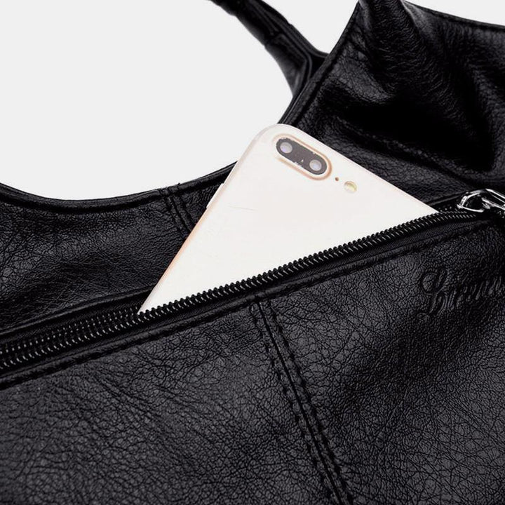 Weiche Lederhandtasche mit Nähten und fester Umhängetasche