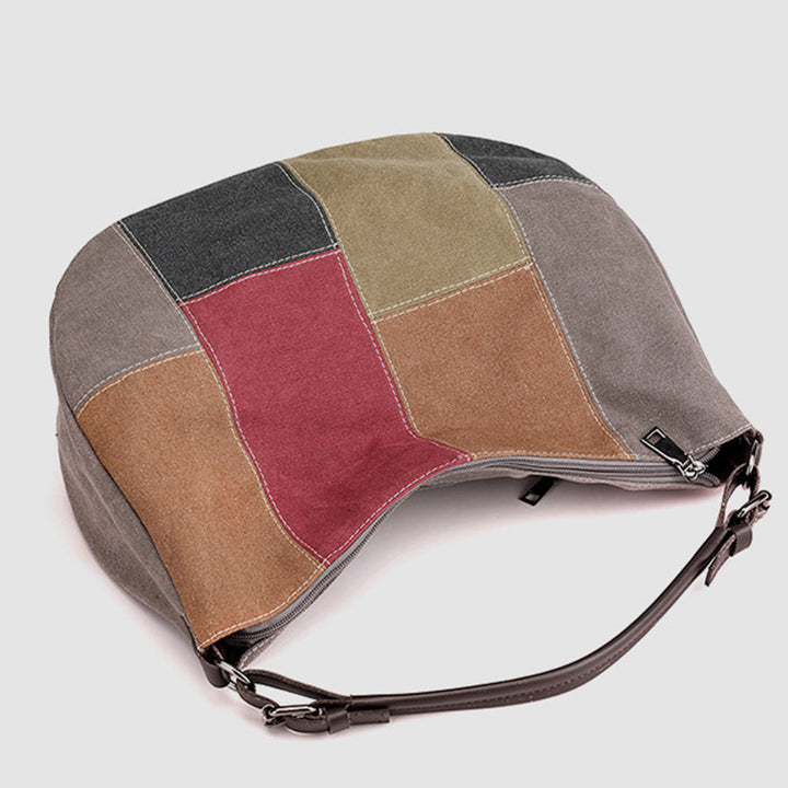 Große Umhängetasche mit Vintage-Nähten und farbigen Knödeln