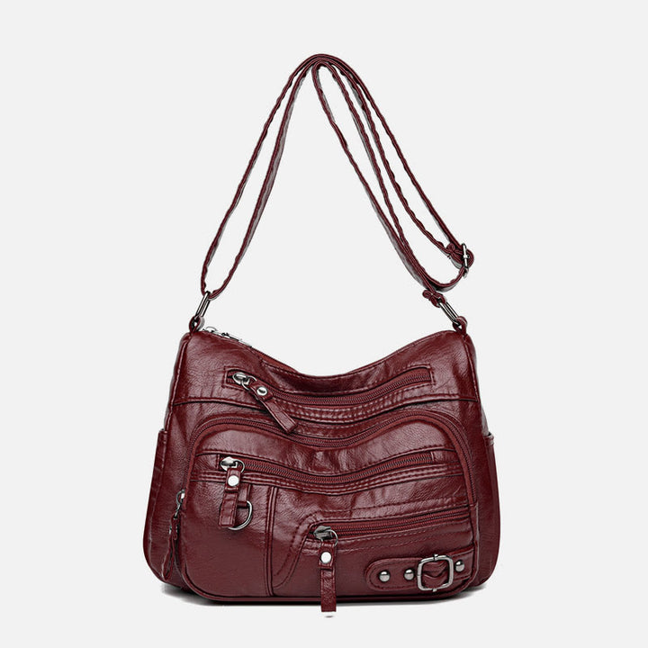 Minimalistische Ledergeldbörse mit mehreren Taschen für Damen. Organisierte Umhängetasche