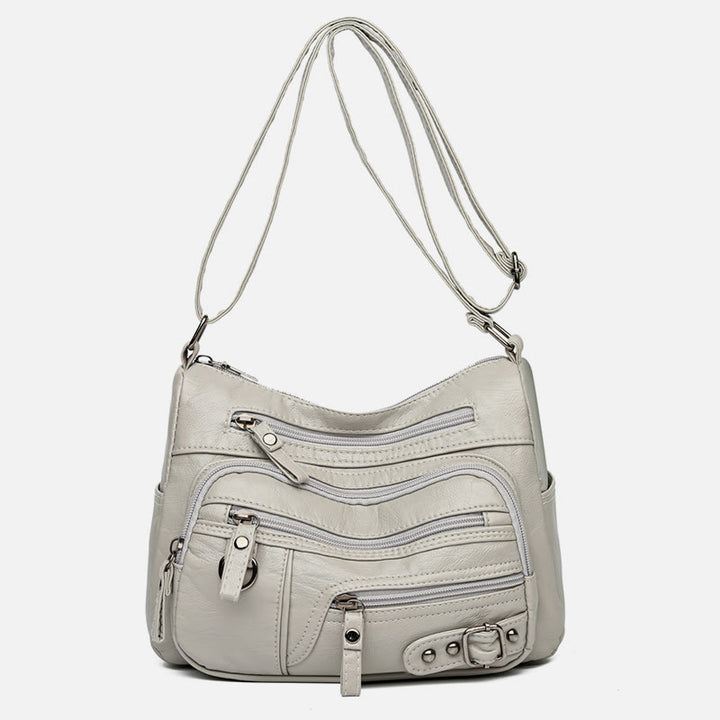 Minimalistische Ledergeldbörse mit mehreren Taschen für Damen. Organisierte Umhängetasche