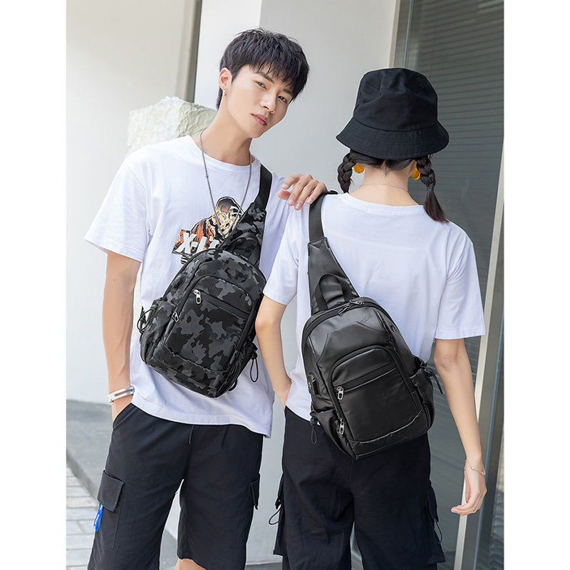 Kleine schwarze Sling-Umhängetasche für Damen und Herren, Tagesrucksack mit USB-Ladegerät