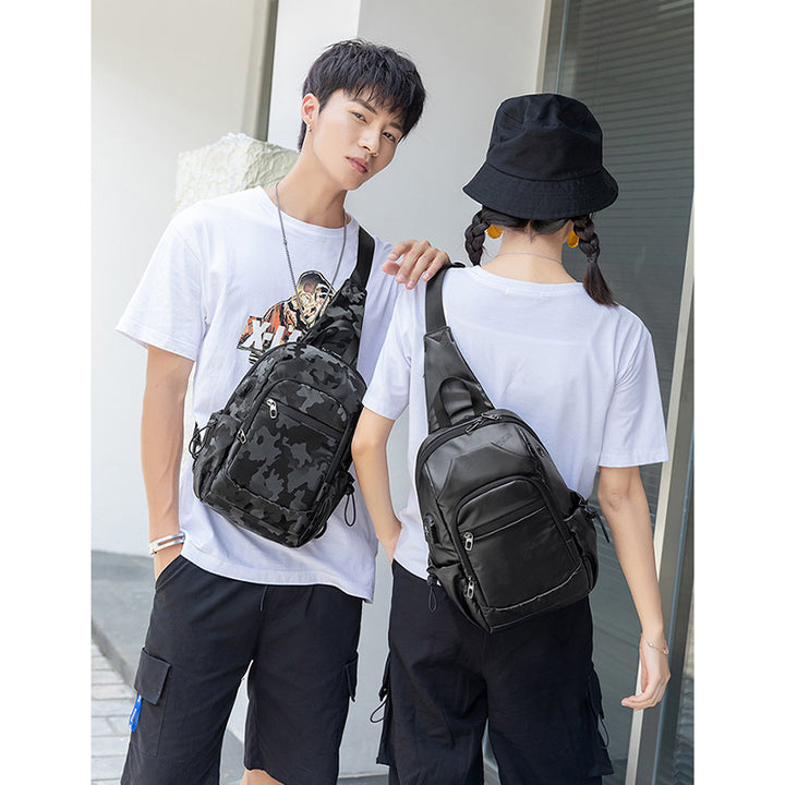 Kleine schwarze Sling-Umhängetasche für Damen und Herren, Tagesrucksack mit USB-Ladegerät