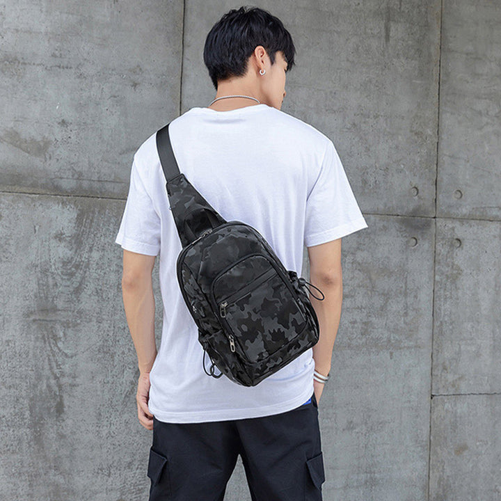 Kleine schwarze Sling-Umhängetasche für Damen und Herren, Tagesrucksack mit USB-Ladegerät
