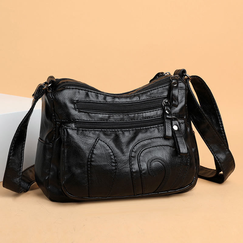 Minimalistische Tragetasche aus weichem Leder mit breitem Schultergurt