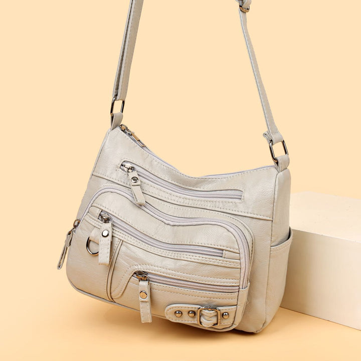 Minimalistische Ledergeldbörse mit mehreren Taschen für Damen. Organisierte Umhängetasche