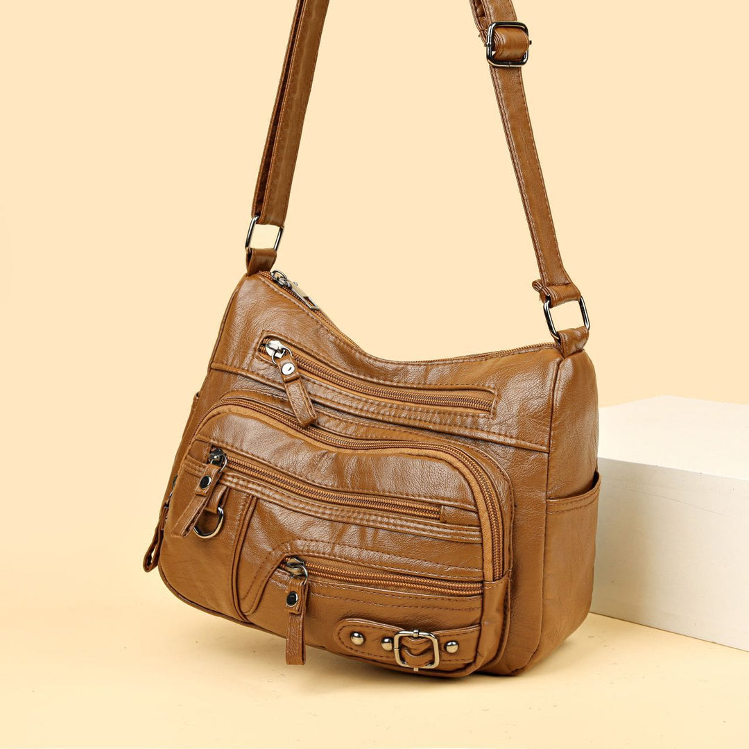 Minimalistische Ledergeldbörse mit mehreren Taschen für Damen. Organisierte Umhängetasche